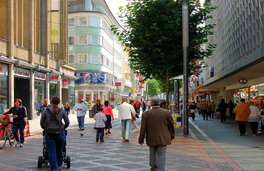 Eine Einkaufsstraße wo viele Menschen unterwegs sind